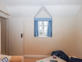 A snug room with a window and door at Yew Tree Cottage in Stoke Fleming