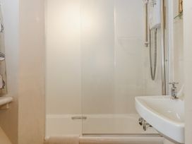 A bathroom with shower and sink at Yew Tree Cottage Stoke Fleming
