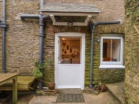 An entrance with a door and window at Yew Tree Cottage in Stoke Fleming