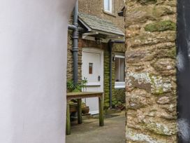 An outdoor area with a door and table at Yew Tree Cottage in Stoke Fleming