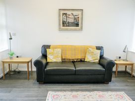 A living room with a sofa and side tables at 2 Mountain View in Talwrn near Llangefni