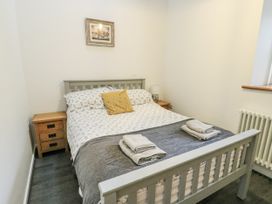 A bedroom with a bed and bedside tables at 2 Mountain View Talwrn near Llangefni