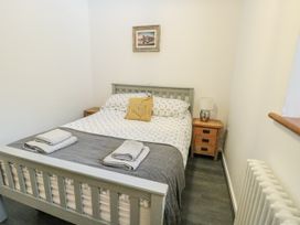 A bedroom with a bed and bedside tables at 2 Mountain View in Talwrn near Llangefni