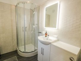 A bathroom with a shower and sink at 2 Mountain View in Talwrn near Llangefni