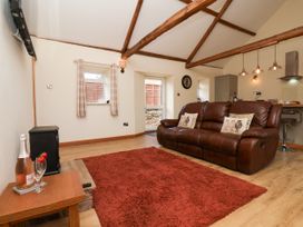 A living room with a sofa and coffee table at Crabtree Cottage in Suffield near Scalby