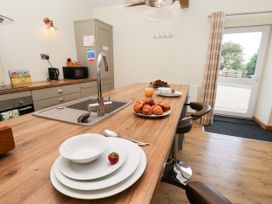 A kitchen with an island and breakfast items at Crabtree Cottage in Suffield near Scalby