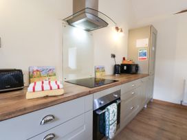A kitchen with appliances and towels at Crabtree Cottage Suffield near Scalby