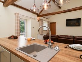 A kitchen with a sink and wooden countertop at Crabtree Cottage Suffield near Scalby