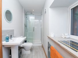 A bathroom with sink, shower, and toilet at Crabtree Cottage Suffield near Scalby
