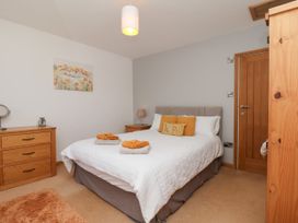 A bedroom with a bed and furniture at Crabtree Cottage Suffield near Scalby