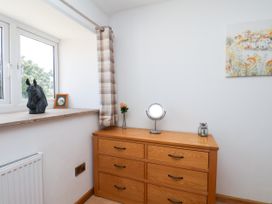 A bedroom with a chest of drawers and a window at Crabtree Cottage Suffield near Scalby