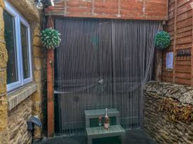 An outdoor area with a table and plants at Crabtree Cottage Suffield near Scalby