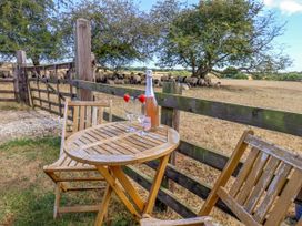 A table and chairs with drinks overlooking a field at Crabtree Cottage in Suffield near Scalby