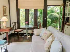 A living room with a sofa and table at The Barn at Frog Pond Farm Antsy near Tisbury