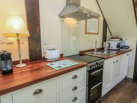 A kitchen with appliances including a stove and microwave at The Barn at Frog Pond Farm Antsy near Tisbury