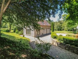 An exterior view of a building surrounded by greenery at The Barn at Frog Pond Farm near Tisbury