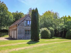 A house surrounded by trees and grass at The Barn at Frog Pond Farm Antsy near Tisbury