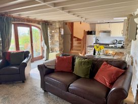 A living room with a sofa and armchairs at Stable Cottage in Newport, Pembrokeshire