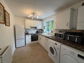 A kitchen with appliances and cabinets at Derlwyn, Newport, Pembrokeshire