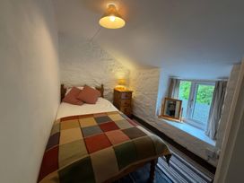 A bedroom with a bed and a nightstand at Derlwyn Newport, Pembrokeshire