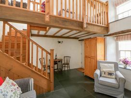 A living room featuring a dining table and chairs at West End Cottage Newport, Pembrokeshire