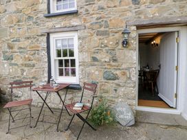 An outdoor area with a table and chairs at West End Cottage in Newport, Pembrokeshire
