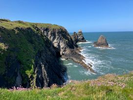 A coastal view with cliffs and ocean at West End Cottage in Newport, Pembrokeshire