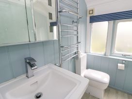 A bathroom with a sink and a toilet at Clifftop Carriage in Aberporth, Ceredigion