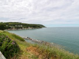 A coastline with cliffs and ocean at Clifftop Carriage in Aberporth, Ceredigion