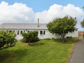 A house with garden and trees at Clifftop Carriage in Aberporth, Ceredigion