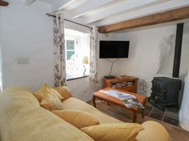 A living room with a sofa and television at End Cottage in Newport, Pembrokeshire