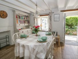 A dining room with a table and chairs at End Cottage in Newport, Pembrokeshire