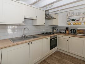 A kitchen with sink, stove, and oven at End Cottage in Newport, Pembrokeshire