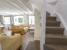 A living room with a sofa and armchair at End Cottage Newport, Pembrokeshire