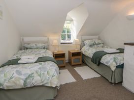 A bedroom with two beds and nightstands at End Cottage Newport, Pembrokeshire