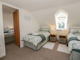 A bedroom with two single beds and bedside tables at End Cottage in Newport, Pembrokeshire