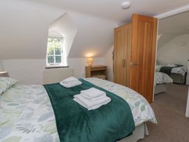 A bedroom with a bed and bedside table at End Cottage Newport, Pembrokeshire