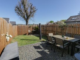 A garden with seating and a tree at End Cottage Newport, Pembrokeshire