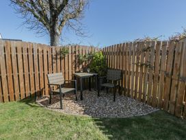 A garden area with a table and chairs at End Cottage Newport, Pembrokeshire