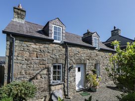 An exterior view of a stone house with plants at End Cottage in Newport, Pembrokeshire