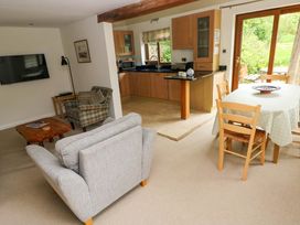 A living room with a television and dining area at Brynawelon, Newport, Pembrokeshire