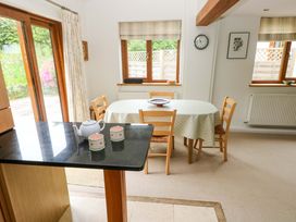 A kitchen with a table and chairs at Brynawelon in Newport, Pembrokeshire