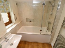 A bathroom with a bathtub and shower at Brynawelon Newport, Pembrokeshire