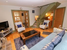 A living room with a sofa and coffee table at Greenbanks, Dinas Cross, Pembrokeshire