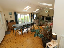 A dining room with a table and chairs at Greenbanks in Dinas Cross, Pembrokeshire