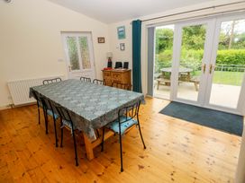A dining room with a large table and chairs at Greenbanks Dinas Cross Pembrokeshire