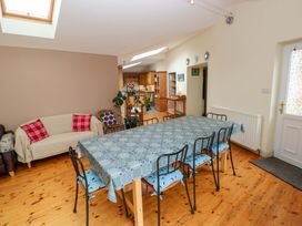 A dining room with a table and chairs at Greenbanks in Dinas Cross, Pembrokeshire