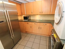 A kitchen with refrigerator and microwave at Greenbanks in Dinas Cross, Pembrokeshire