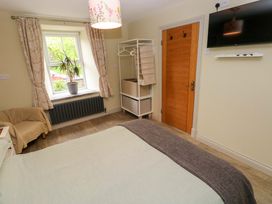 A bedroom with a bed and a window at Greenbanks in Dinas Cross, Pembrokeshire