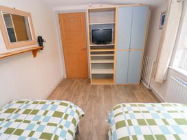 A bedroom with two beds and a television at Greenbanks Dinas Cross, Pembrokeshire
